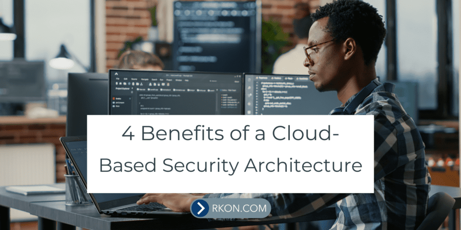 Man sitting at computer desk. 4 Benefits of a Cloud-Based Security Architecture