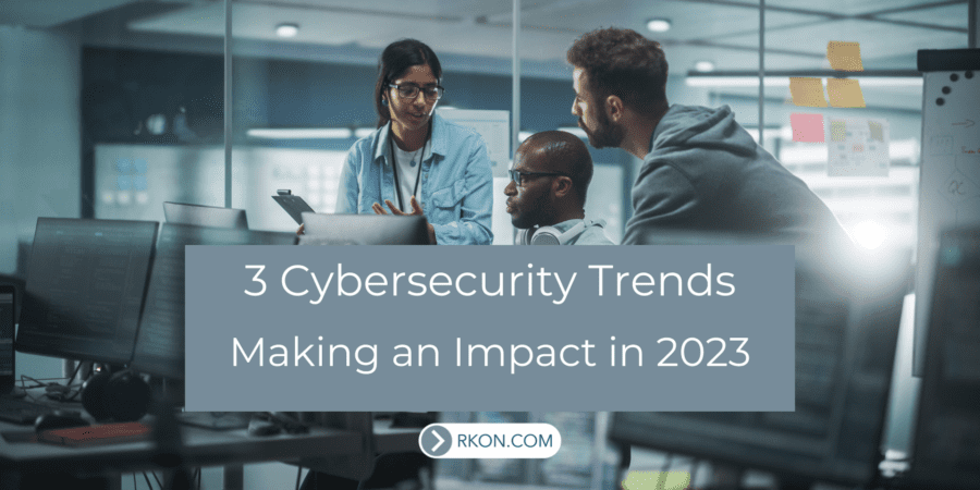 Group of workers around computer desk. 3 Cybersecurity Trends Making an Impact in 2023